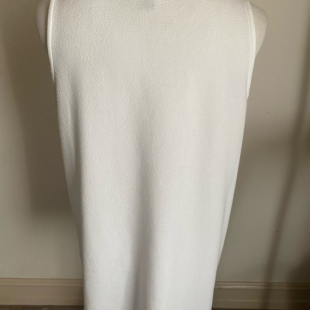 White sleeveless peplum shirt